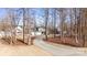 House with a long driveway, surrounded by trees at 174 Country Lake Dr, Mooresville, NC 28115