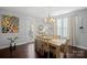 Bright dining room with hardwood floors, farmhouse table, and access to a patio at 174 Country Lake Dr, Mooresville, NC 28115