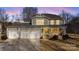 Two-story house with gray siding, three-car garage, and a front porch, at dusk at 174 Country Lake Dr, Mooresville, NC 28115