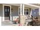 Front porch with stone pillars, chairs, and potted plants at 174 Country Lake Dr, Mooresville, NC 28115