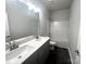 Bathroom with double vanity, shower/tub combo and dark tile floor at 174 Swann Rd # 3, Statesville, NC 28625