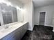 Double vanity bathroom with gray cabinets and dark floor tile at 174 Swann Rd, Statesville, NC 28265