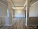 Bright dining room with hardwood floors, tray ceiling, and wainscoting at 174 Swann Rd, Statesville, NC 28265