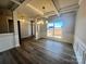 Bright dining room with hardwood floors, tray ceiling, and wainscoting at 174 Swann Rd, Statesville, NC 28265