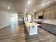 Modern kitchen with gray cabinets, white backsplash, and large island at 174 Swann Rd, Statesville, NC 28265