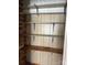 Empty pantry with wooden shelves and brick wall at 1915 Pleasant Hill Church Rd, Shelby, NC 28152