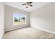 Empty bedroom with carpet flooring, ceiling fan and large window at 211 Benfield Rd, Kings Mountain, NC 28086