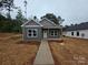 A cozy home with modern siding, white-framed windows, and a inviting front porch at 211 Benfield Rd, Kings Mountain, NC 28086