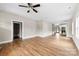 Spacious living room with hardwood floors, ceiling fan, and open access to the bathroom and kitchen at 211 Benfield Rd, Kings Mountain, NC 28086