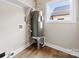 Utility room with hot water heater and updated flooring at 211 Benfield Rd, Kings Mountain, NC 28086