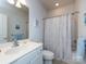 Bright bathroom with neutral color palette, shower with curtain, and sink at 21222 W Tern Ct, Fort Mill, SC 29707