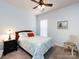 Bedroom with neutral carpet, ceiling fan, and large window at 21222 W Tern Ct, Fort Mill, SC 29707