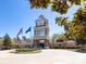 Beautiful community center featuring a clock tower, American and community flags, and well-maintained grounds at 21222 W Tern Ct, Fort Mill, SC 29707