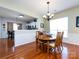 Charming dining room featuring hardwood floors, a chandelier, and wainscoting details at 21222 W Tern Ct, Fort Mill, SC 29707