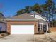 Charming single-story home boasts a brick facade and a spacious two-car garage with a concrete driveway at 21222 W Tern Ct, Fort Mill, SC 29707