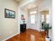 Bright foyer with hardwood floors, decorative trim, and a charming accent table and artwork at 21222 W Tern Ct, Fort Mill, SC 29707