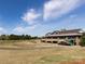 Expansive golf course with lush green fairways and a well-appointed clubhouse under a sunny sky at 21222 W Tern Ct, Fort Mill, SC 29707