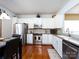 Modern kitchen with stainless steel appliances, granite countertops, and white cabinetry at 21222 W Tern Ct, Fort Mill, SC 29707