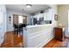 Open kitchen area with stainless steel appliances, bar seating, and hardwood floors at 21222 W Tern Ct, Fort Mill, SC 29707