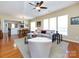 Spacious living room with an open floor plan, a ceiling fan, and a view of the dining area at 21222 W Tern Ct, Fort Mill, SC 29707