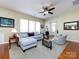 Comfortable living room features hardwood floors, bright windows, and a large sectional sofa at 21222 W Tern Ct, Fort Mill, SC 29707