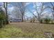 Spacious backyard with a large grassy area and mature trees at 225 Spencer St, Rock Hill, SC 29730