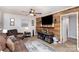 Living room with brown couches, a large TV, and wood wall at 225 Spencer St, Rock Hill, SC 29730