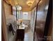 Well-lit bathroom featuring a stained glass window, white tile, and patterned shower curtain at 225 Wilson St, Albemarle, NC 28001