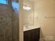 Bathroom with vanity, shower, and tiled walls at 240 Harrison Ln, Locust, NC 28097