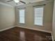 Spacious bedroom with hardwood floors and window blinds at 240 Harrison Ln, Locust, NC 28097