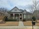 Brick ranch home with stone accents, covered porch, and landscaped yard at 240 Harrison Ln, Locust, NC 28097