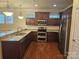 Modern kitchen with granite countertops and stainless steel appliances at 240 Harrison Ln, Locust, NC 28097