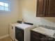 Laundry room with washer, dryer, and sink at 240 Harrison Ln, Locust, NC 28097