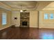 Living room features hardwood floors, stone fireplace, and ceiling fan at 240 Harrison Ln, Locust, NC 28097