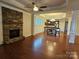 Open living space with hardwood floors, stone fireplace, and kitchen view at 240 Harrison Ln, Locust, NC 28097