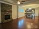 Open living space with hardwood floors, stone fireplace, and kitchen view at 240 Harrison Ln, Locust, NC 28097