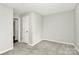 Neutral bedroom showing carpet and neutral paint, two doorways, and a double closet at 2520 Lower Stone Church Rd, Rockwell, NC 28138