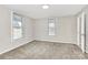 Neutral bedroom features two windows and carpet at 2520 Lower Stone Church Rd, Rockwell, NC 28138