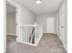 Bright hallway with neutral paint, carpet, white doors and trim creates a clean aesthetic at 2520 Lower Stone Church Rd, Rockwell, NC 28138