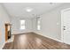 Bright living room featuring a classic fireplace and warm wood flooring at 2520 Lower Stone Church Rd, Rockwell, NC 28138