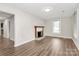 Bright living room featuring a classic fireplace and warm wood flooring at 2520 Lower Stone Church Rd, Rockwell, NC 28138