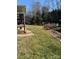 Landscaped backyard with grassy area and rock retaining wall at 2521 Whistler Ct, Newton, NC 28658