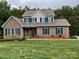 Brick house with landscaped yard and teal shutters at 2521 Whistler Ct, Newton, NC 28658