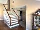 Elegant staircase with wooden banister and white risers at 2521 Whistler Ct, Newton, NC 28658