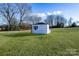 White shed with black shutters in a grassy backyard at 2961 Great Falls Hwy, Lancaster, SC 29720