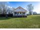 White house with a porch, brick base, and American flag at 2961 Great Falls Hwy, Lancaster, SC 29720