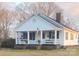 White house with a porch and lush landscaping at 2961 Great Falls Hwy, Lancaster, SC 29720