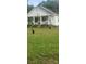 White house with a front porch, and two black chickens in the front yard at 2961 Great Falls Hwy, Lancaster, SC 29720