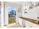 Bright laundry room with white cabinets and Whirlpool washer at 2961 Great Falls Hwy, Lancaster, SC 29720