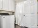 White cabinets and a Whirlpool washer in the laundry room at 2961 Great Falls Hwy, Lancaster, SC 29720